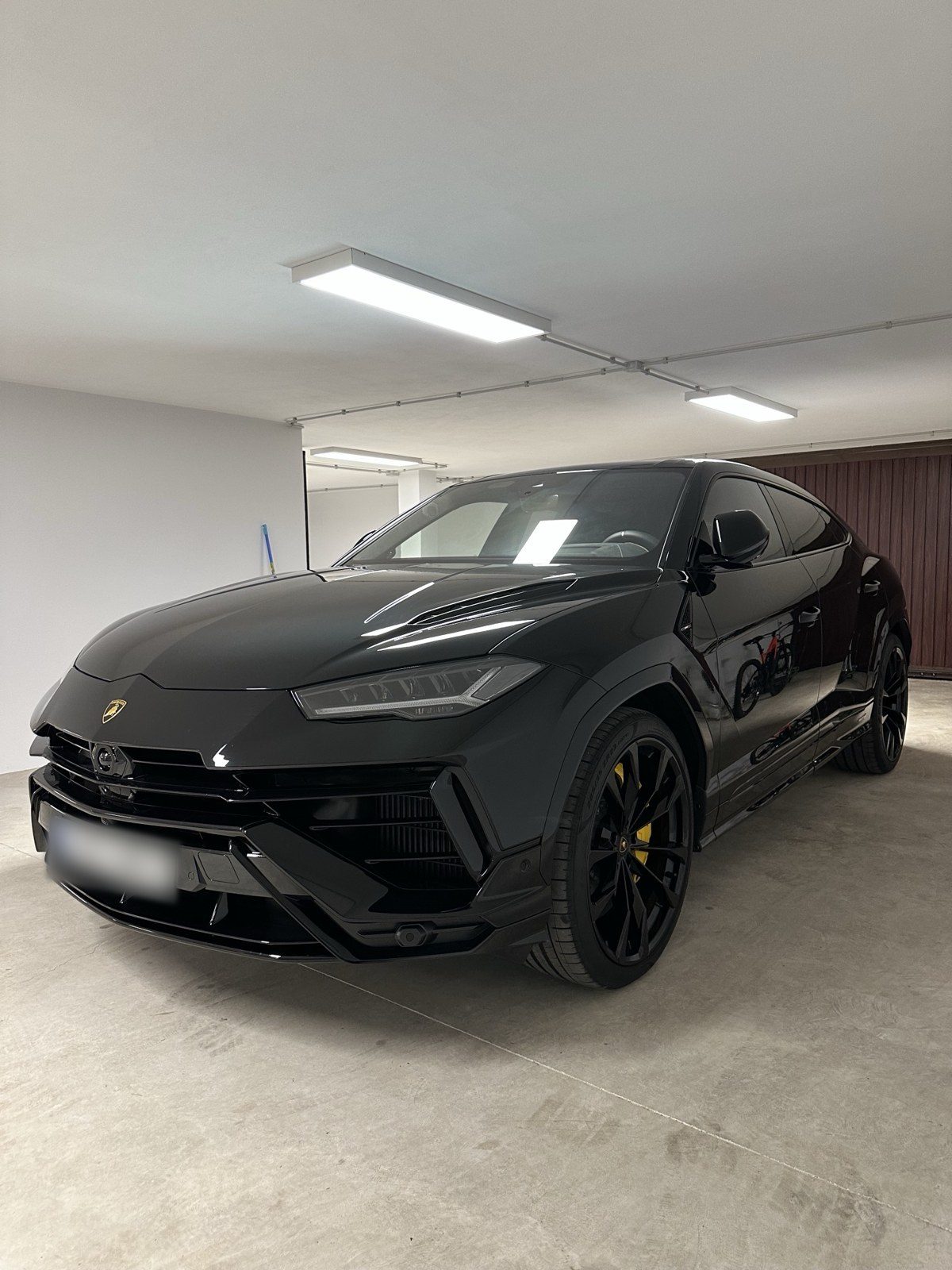 Black luxury SUV parked in a clean private garage